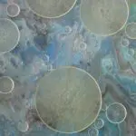Large and small translucent bubbles float over a marbled blue, gray, and black background, creating an abstract, fluid pattern.