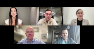 A virtual meeting with five professionals, three men and two women, each in their own space, looking at their cameras. Names and titles are displayed for some participants at the bottom of their video frames.