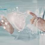 A doctor interacts with a transparent digital screen displaying a 3D heart model, medical icons, and health data, including a heart rate graph, in a futuristic medical setting.
